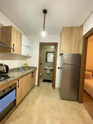 a kitchen with a stainless steel refrigerator and a bathroom at Appart26 Marrakech guéliz en face la Gare in Marrakech