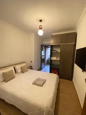 a bedroom with a large white bed in a room at Appart26 Marrakech guéliz en face la Gare in Marrakech