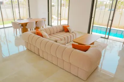 a living room with a couch and a table at Villa émeraude - Route Ourika in Marrakech