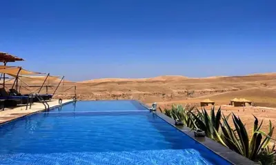 a swimming pool in the middle of the desert at Marrakech appartement in Marrakech