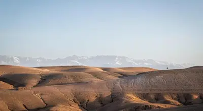 a view of a desert with mountains in the background at Marrakech appartement in Marrakech