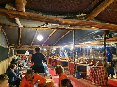 a group of people sitting at tables in a tent at Marrakech appartement in Marrakech