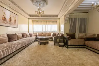 a large living room with couches and a chandelier at Elegant apartment downtown in Marrakech