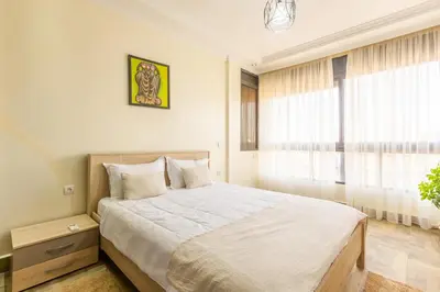 a bedroom with a large bed and a window at Elegant apartment downtown in Marrakech