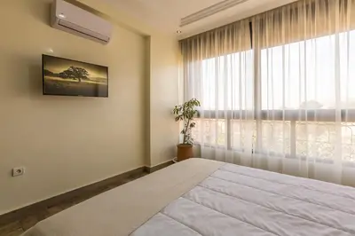a bedroom with a bed and a large window at Elegant apartment downtown in Marrakech