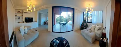 a living room with two white couches and a television at Magnifique appartement in Marrakech