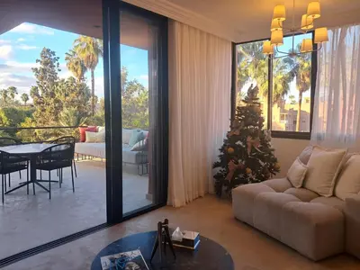 a living room with a christmas tree in a room at Magnifique appartement in Marrakech