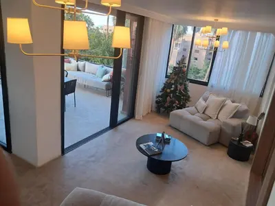 a living room with a christmas tree and a couch at Magnifique appartement in Marrakech