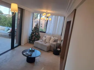 a living room with a christmas tree and a couch at Magnifique appartement in Marrakech