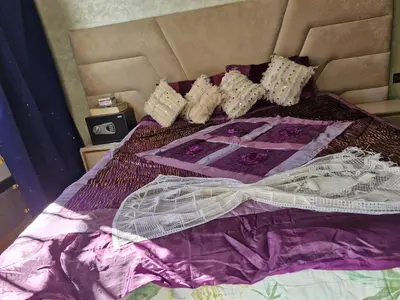 a bed with a purple comforter with a bow on it at apprtement near the airport in Marrakech