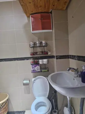 a bathroom with a toilet and a sink at apprtement near the airport in Marrakech