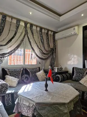 a living room with a table and a couch at apprtement near the airport in Marrakech