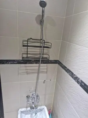 a bathroom with a toilet in a tiled room at apprtement near the airport in Marrakech