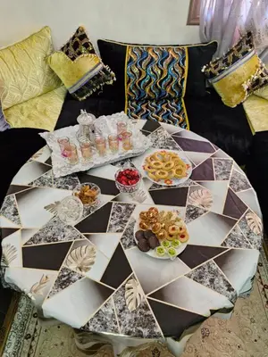 a table with plates of food on a couch at apprtement near the airport in Marrakech