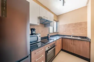 a kitchen with a sink and a stove top oven at Modern Appart-Golf View, Terrace & Fiber Optic in Marrakech