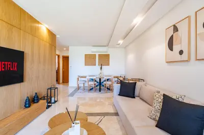 a living room with a couch and a table at Modern Appart-Golf View, Terrace & Fiber Optic in Marrakech