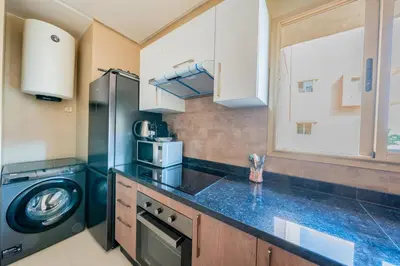 a kitchen with a washing machine and a washer at Modern Appart-Golf View, Terrace & Fiber Optic in Marrakech