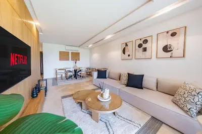 a living room with a couch and a table at Modern Appart-Golf View, Terrace & Fiber Optic in Marrakech