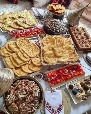 a table topped with lots of different types of food at apartment sur GOLF prestigia avec piscine in Marrakech