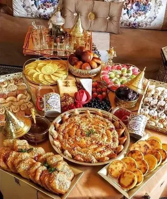 a table topped with lots of different types of food at apartment sur GOLF prestigia avec piscine in Marrakech