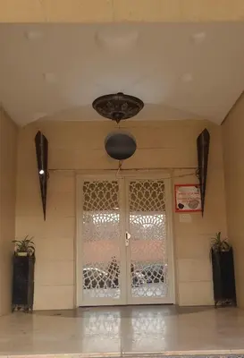 a room with a glass door with a window at Le Chaleureux 34 face de la gare CTM Hivernage in Marrakech