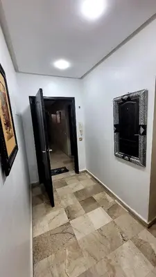 a living room with a television and a tiled floor at Le Chaleureux 34 face de la gare CTM Hivernage in Marrakech