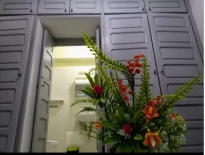 a vase of flowers in front of a mirror at LOGEMENT ENTIER MARRAKECh G1 - N3 in Marrakech