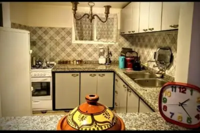 a kitchen with a counter top with a clock on it at LOGEMENT ENTIER MARRAKECh G1 - N3 in Marrakech