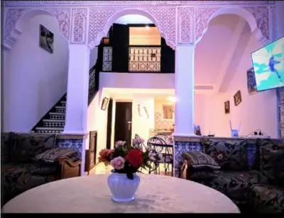a vase with flowers sitting on a table in a room at LOGEMENT ENTIER MARRAKECh G1 - N3 in Marrakech