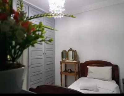 a bedroom with a bed and a vase of flowers at LOGEMENT ENTIER MARRAKECh G1 - N3 in Marrakech