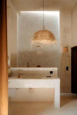 a bathroom with a white sink and a large mirror at Riad Roca in Marrakech