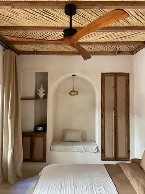 a bedroom with a bed and a ceiling fan at Riad Roca in Marrakech