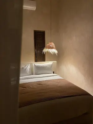 a bedroom with a bed and a pendant light at Riad Roca in Marrakech