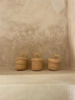 three wicker baskets sitting on top of a shelf at Riad Roca in Marrakech