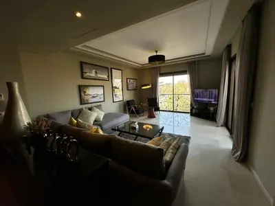 a living room with a couch and a table at Duplex à l hivernage in Marrakech