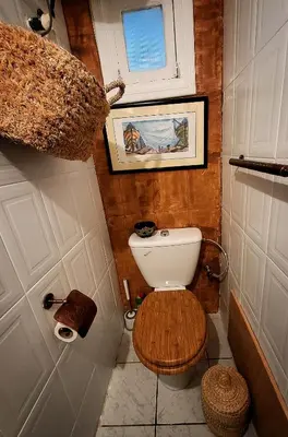 a small bathroom with a toilet and a window at Riad Marhaba Marrakech in Marrakech
