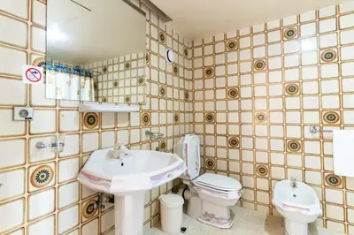 a bathroom with a sink and a toilet at Hotel Le Grand Imilchil in Marrakech