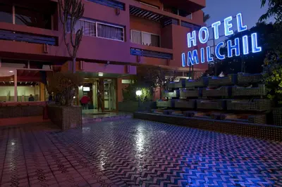 a hotel with a sign on the side of a building at Hotel Le Grand Imilchil in Marrakech
