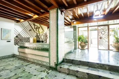 a lobby of a building with a staircase at Hotel Le Grand Imilchil in Marrakech