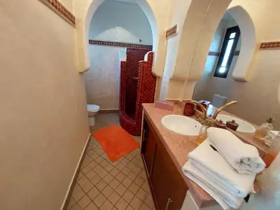 a bathroom with a sink and a mirror at Jasmin d'Atlas in Marrakech