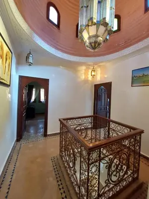 a staircase in a room with a chandelier at Jasmin d'Atlas in Marrakech