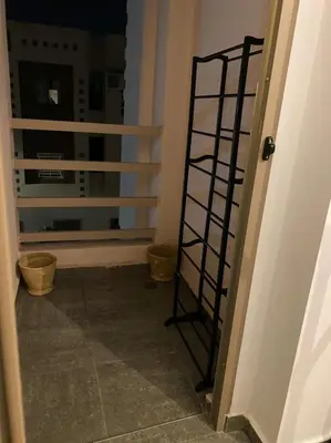 a spiral staircase in a room with a window at Appartement au Cœur de Guéliz in Marrakech