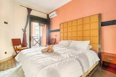 a dog laying on a bed in a bedroom at Havre de paix in Marrakech