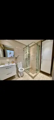 a bathroom with a glass shower and a toilet at Prestigia réve in Marrakech