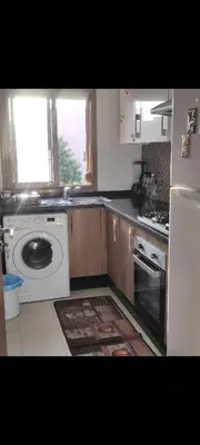 a kitchen with a washing machine and a washer at Prestigia réve in Marrakech
