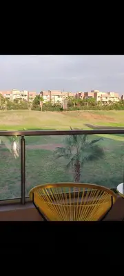 a view of a palm tree from a window at Prestigia réve in Marrakech