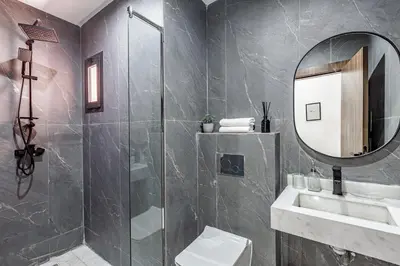 a bathroom with a shower and a sink and a mirror at Serenite tranquille au coeur du centre ville in Marrakech