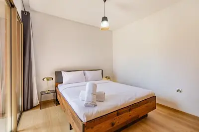 a bedroom with a bed with two towels on it at Luxury Garden-Level Apartment with Poolside Serenity in Marrakech