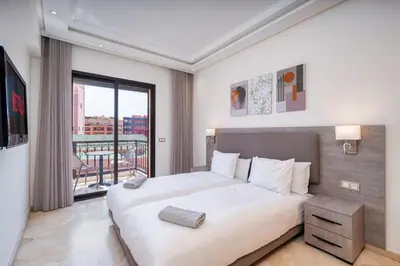 a bedroom with a large bed and a large window at Appart Hyper-Centre Gueliz - Wifi - Netflix in Marrakech
