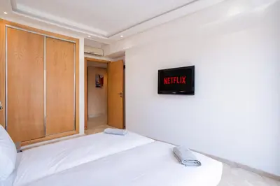 a bedroom with a bed and a sign on the wall at Appart Hyper-Centre Gueliz - Wifi - Netflix in Marrakech